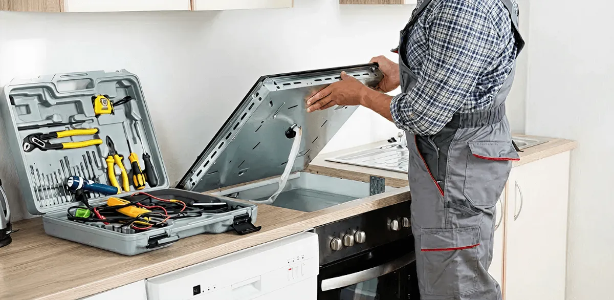 Handyman repairing a cooktop and checking wiring connections in Memphis, TN