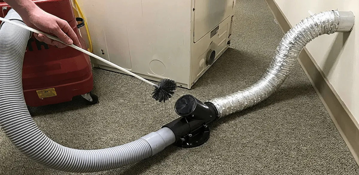 Dryer vent cleaning service removing lint from a dryer duct connection in Memphis, TN