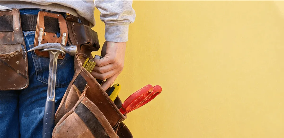 Handyman with tool belt ready for home repairs and maintenance in Memphis, TN