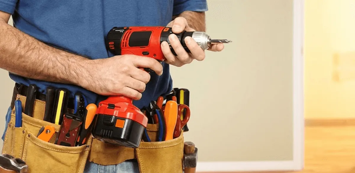 Handyman holding a power drill for home repairs and installations in Memphis, TN