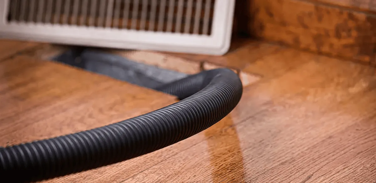 Air duct cleaning hose inserted into a floor vent for ductwork cleaning in Memphis, TN